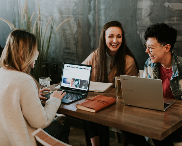 Corporate Event Planner - Three Women Working On Laptops In Coffee Shop